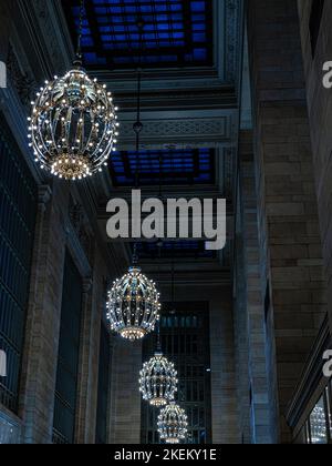 Crystal chandeliers hanging in the majestic beaux - style corridor of the Grand Central Terminal in Midtown Manhattan, New York. Stock Photo