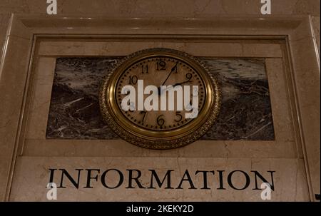 Old vintage clock on marble wall in Grand Central Terminal, New York City, USA. Railroad station clock at information desk. Stock Photo