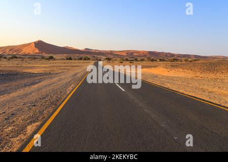 Asphalt road to Soussusvlei located in the southern part of the Namib Desert in the Namib-Naukluft National Park of Namibia. Stock Photo