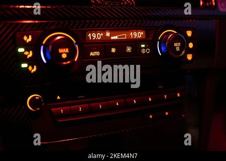 Car dashboard dark ventilation control panel detail. Control panel car air conditioner dashboard or console Technology in a modern car. Driver hand tu Stock Photo