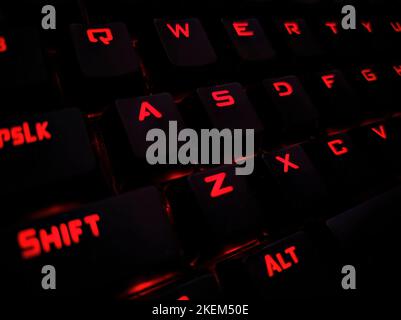 Backlit keyboard close up. Black keys with illuminated characters. Backlight gaming keyboard. Gaming RGB LED backlit keyboard Stock Photo