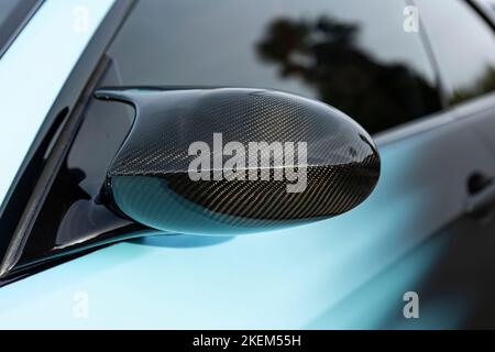 Tuned car rearview mirror in carbon detail Stock Photo