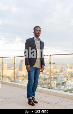 Portrait of handsome black African businessman wearing suit full length shot Stock Photo