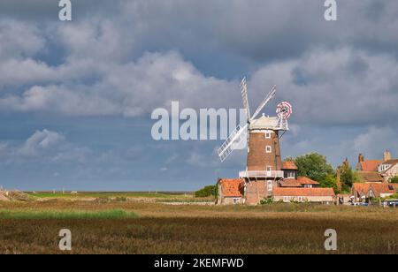 From the North Norfolk Coast Path, a view across the coastal wetlands and the Grade 2 listed tower mill at Cley next the Sea. Stock Photo