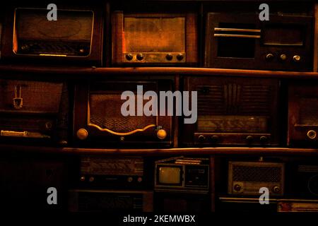 A closeup of stacked old radios retro background Stock Photo