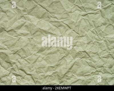 Texture of crumpled green craft paper. Texture, pattern for handcrafts, new year designs decoration, text, lettering, wall screen saver or other art Stock Photo