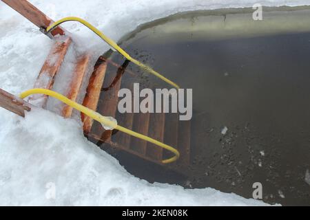 Wooden ladder to descend into the ice pool Stock Photo
