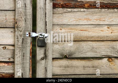 Padlock on wooden gate Stock Photo