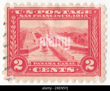 USA - 1915: An 2 cent carmine postage stamp depicting Pedro Miguel Locks, Panama Canal. Opening of Panama Canal inscribed 'SAN FRANCISCO 1915'. The Panama Canal locks are a lock system that lifts ships up 26 metres to the main elevation of the Panama Canal and down again. The original canal had a total of six steps (three up, three down) for a ship's passage. The total length of the lock structures, including the approach walls, is over 3 km. The locks were one of the greatest engineering works ever to be undertaken when they opened in 1914 Panama–Pacific International Exposition issue Stock Photo