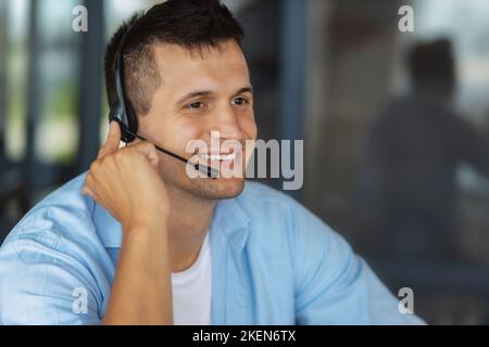 Male employee customer support services in headset, online consultation. Man call center, customer support Stock Photo