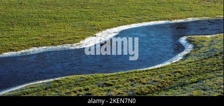 Frozen pools of water in the farmland pastures of the Conwy Valley on a frosty winters day in Snowdonia National Park Gwynedd North Wales UK. Stock Photo