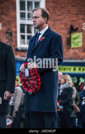 Hereford, UK. 13th Nov, 2022. Conservative MP Jesse Norman lays a wreath. Hereford marks Remembrance Sunday on the 100th anniversary of the Eleanor Cross in St Peters Square. Designed in the form of an Eleanor Cross, the 30ft high Memorial was unveiled and dedicated on 7th October, 1922 in commemoration of about 2000 Herefordshire service men and women who gave their lives in the 1914-1918 War. Credit: SOPA Images Limited/Alamy Live News Stock Photo