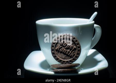 black cookies with a mug on a black background Stock Photo