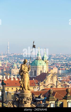 St. Wenceslas statue overlooks Prague city. Sculpture by Cenek Vosmik in Hradcany Square at Prague Castle. Saint with shield and spear against skyline Stock Photo