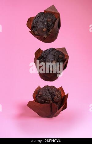levitation of chocolate chip muffins isolated on pink background  Stock Photo