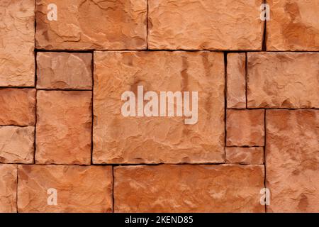 Brown stone wall rough natural stone tiles. Decorative sandstone background Stock Photo
