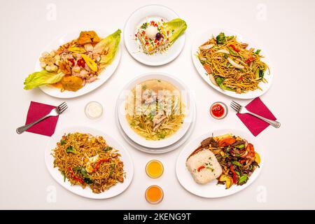 Selection of Peruvian food dishes with lomo saltado with rice, chicken broth, hot pepper, Lima cause, sea bass ceviche Stock Photo