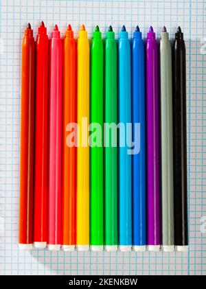 Image of opened multicolored markers on notepad Stock Photo