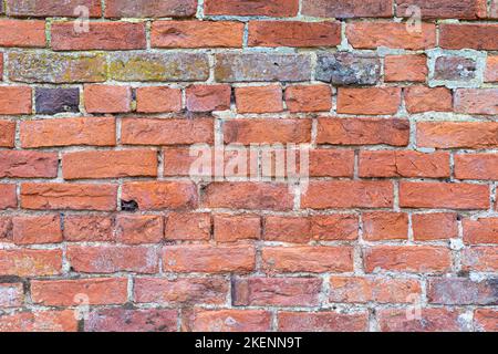 Coursed masonry construction of old, mostly red bricks. Suitable as a background Stock Photo