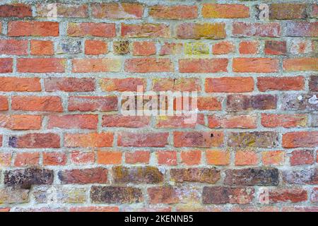 Coursed masonry construction of old, mostly red bricks. Suitable as a background Stock Photo