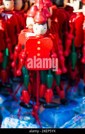 Set of wooden pinocchio dolls with his long nose on a white background Stock Photo