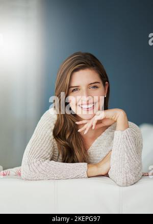 Home is the nicest word there is. a young woman relaxing on her sofa at home. Stock Photo