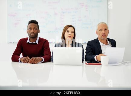 Theyre focused on the presentation. a group of business colleagues sitting in on a presentation. Stock Photo