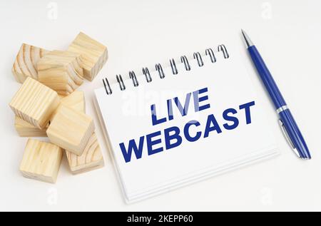 Internet and security concept. On the table are cubes, a pen and a notebook with the inscription - live webcast Stock Photo