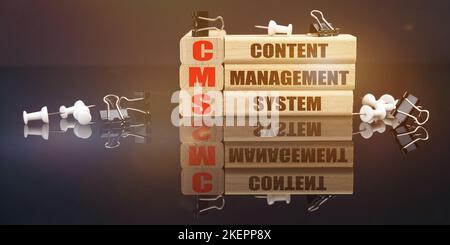 Business and law concept. On a black reflective surface lie buttons and wooden plaques with the inscription - content management system Stock Photo