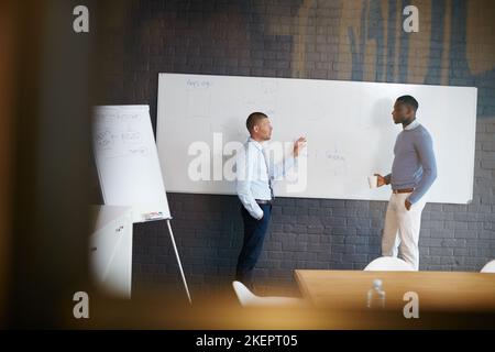 After ambition comes action. two businessmen having a discussion in the boardroom. Stock Photo