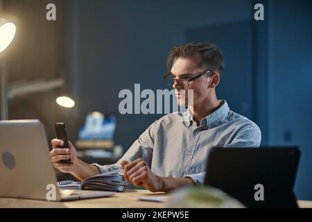 young entrepreneur taking notes in working at night. Stock Photo
