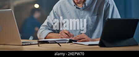 young businessman writing down his ideas in a notebook. Stock Photo