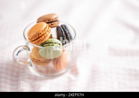 Sweet macaron dessert. Colorful macarons in the cup. Stock Photo