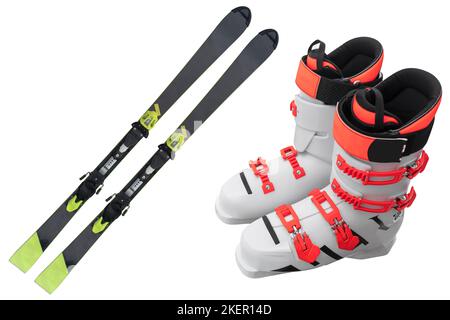 Pair ski boots and alpine skis isolated on white background. Modern sport outdoor equipment isolated. Sport equipment for skiing. Stock Photo