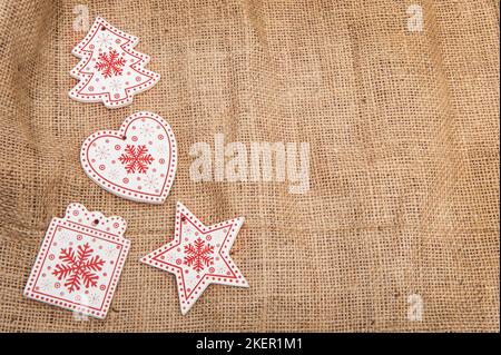 Wooden Christmas decorations on a background of burlap with artificial snow Stock Photo