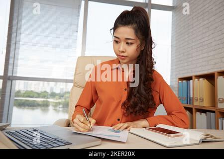 Portrait of female financial analyst working with documents Stock Photo