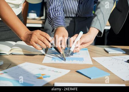 Close-up image of business people pointing at business chart Stock Photo
