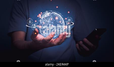 Man using mobile phone and holding globe with Global network communication connection interface, Digital link technology. Stock Photo