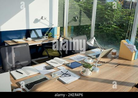 Tables with documents and computers in coworking space Stock Photo