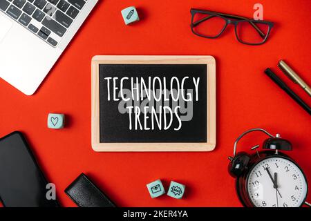 Technology Trends, Tech trends, Top New Technology. Word trends with different gadgets and devices on red background. Stock Photo