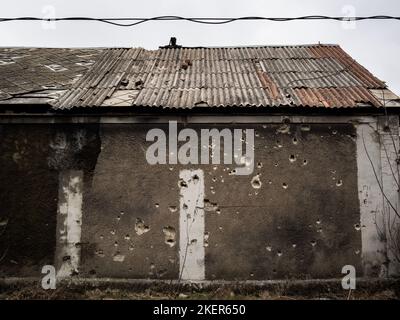 Bullet holes on wall of building close to the out bombed airport in Donetsk. At the date on the area controlled by the 'People republic of Donetsk'. Stock Photo