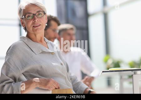 60 year old business woman in a work environment Stock Photo