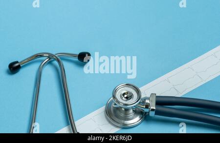 Stethoscope and cardiogram results on blue background. Health care and surgical concept. Stock Photo