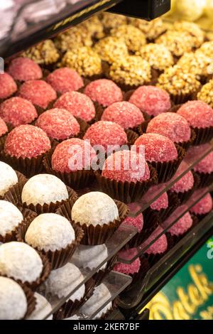 Chocolate varieties. Assortment of truffle chocolates displayed on the counter. Bakery products Stock Photo