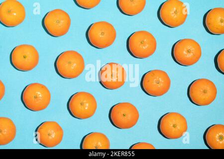 Juicy mandarins arranged on a blue background Stock Photo
