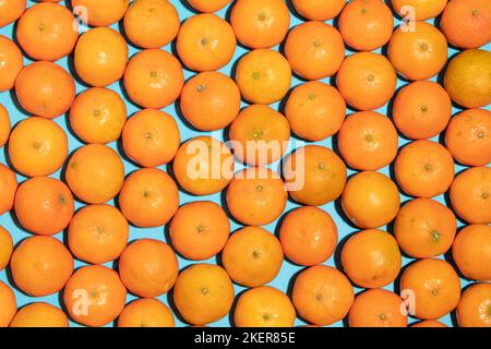 Juicy and healthy mandarins on a blue background Stock Photo