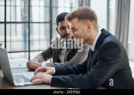 two professional businessmen discussing and using desktop computer in office Stock Photo