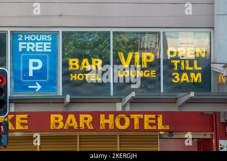 Unlit neon signs in the daytime advertising a Bar Hotel and VIP Lounge ...