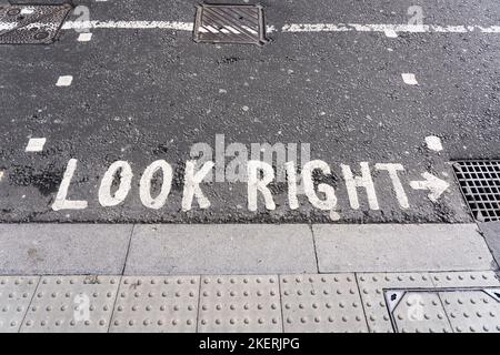 Iconic 'look right' painted road marking for pedestrians in London, England. Concept: crossing the road, road safety, pedestrian safety Stock Photo