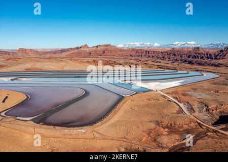 Evaporation ponds at a potash mine using a solution mining method for extracting potash near Moab, Utah.  The La Sal Mountains are in the background. Stock Photo